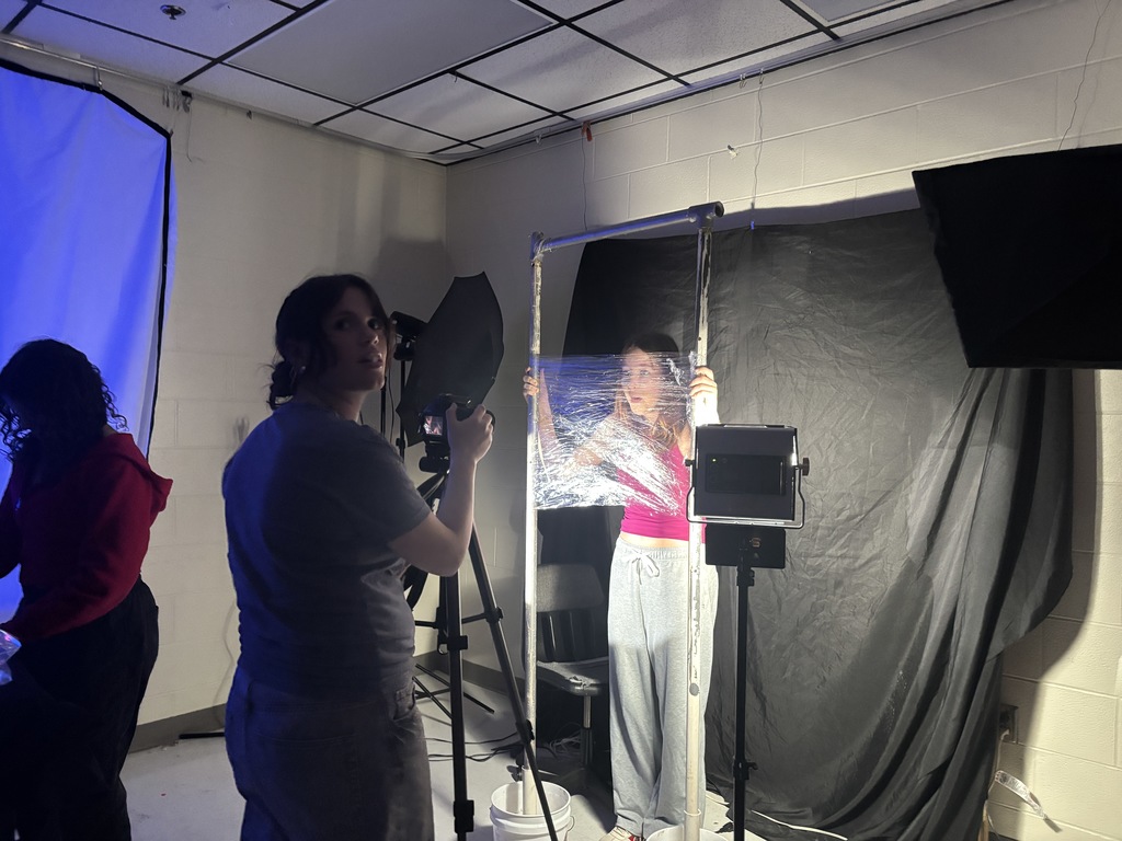 Students work together to create an artistic portrait photograph.