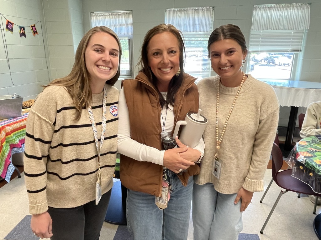 Three staff members pose for a photo at a staff appreciation taco bar lunch.