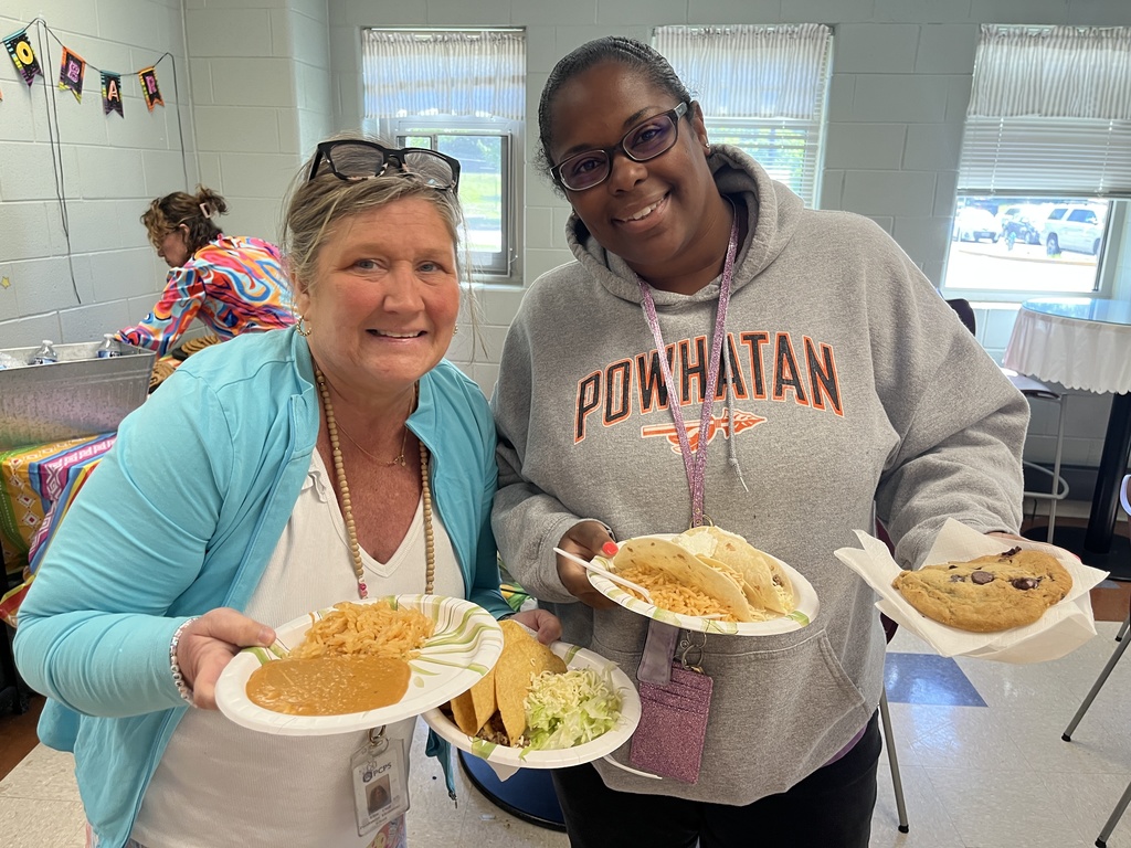 Two  staff members pose for a photo at a staff appreciation taco bar lunch.