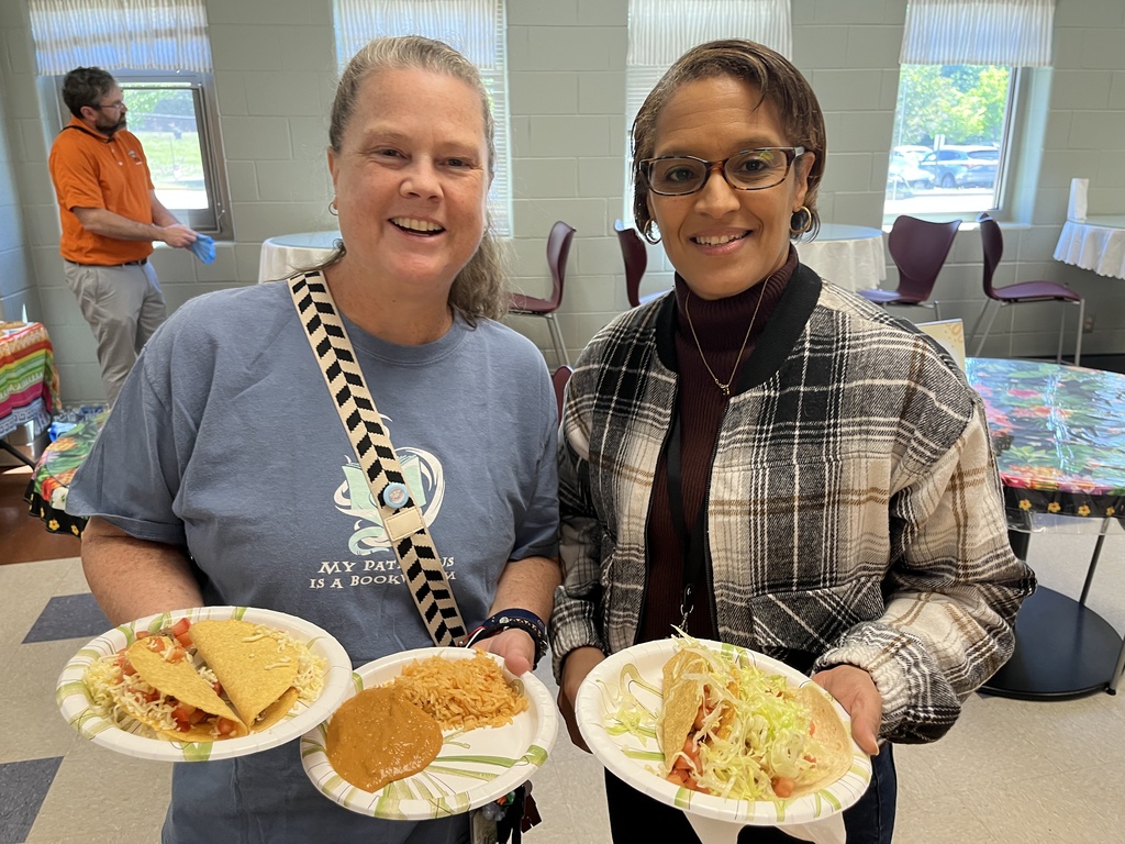 Two  staff members pose for a photo at a staff appreciation taco bar lunch.