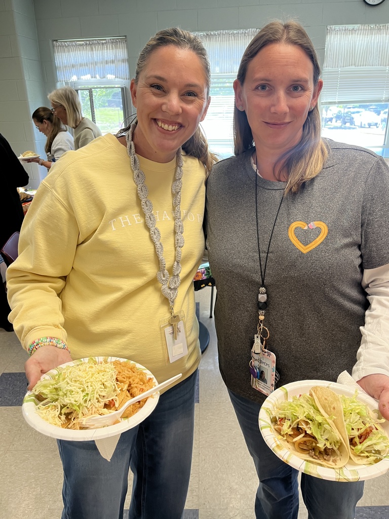 Two  staff members pose for a photo at a staff appreciation taco bar lunch.