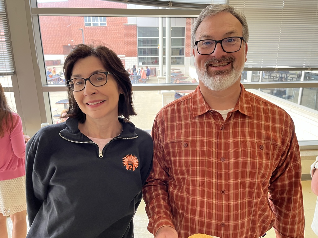 Two staff members pose for a photo at a staff appreciation taco bar lunch.
