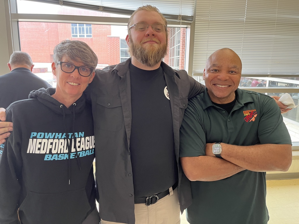 Three staff members pose for a photo at a staff appreciation taco bar lunch.
