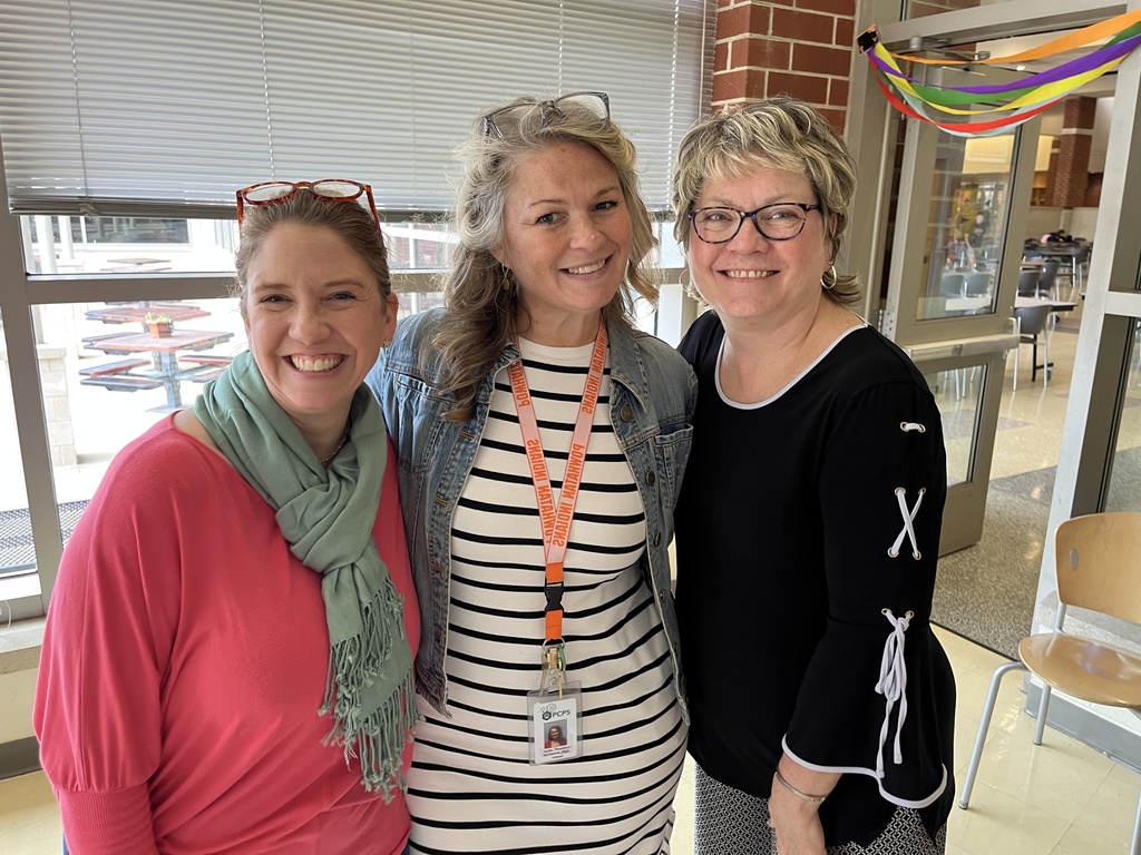 Three staff members pose for a photo at a staff appreciation taco bar lunch.