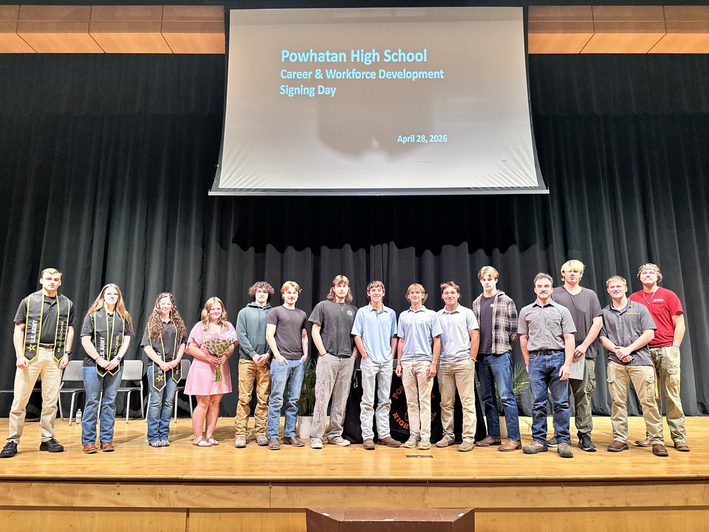 A group of students pose together for a photo at a high school career and workforce development signing day. 