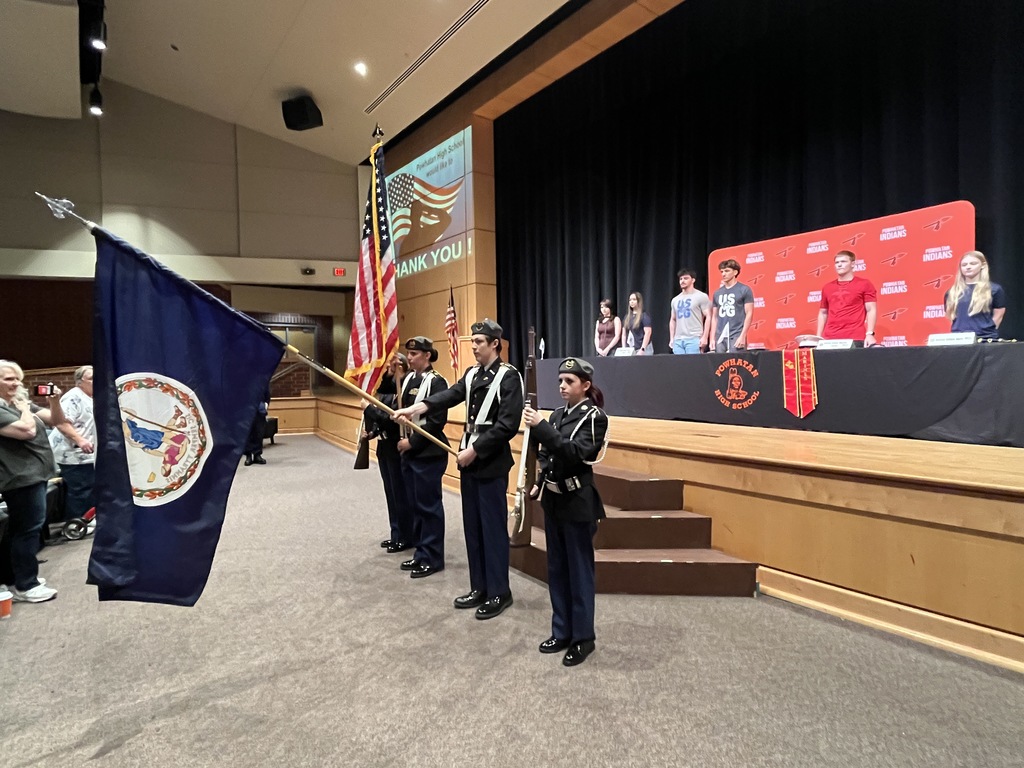 JROTC cadets bring the flags in to present the colors at a military signing day ceremony.