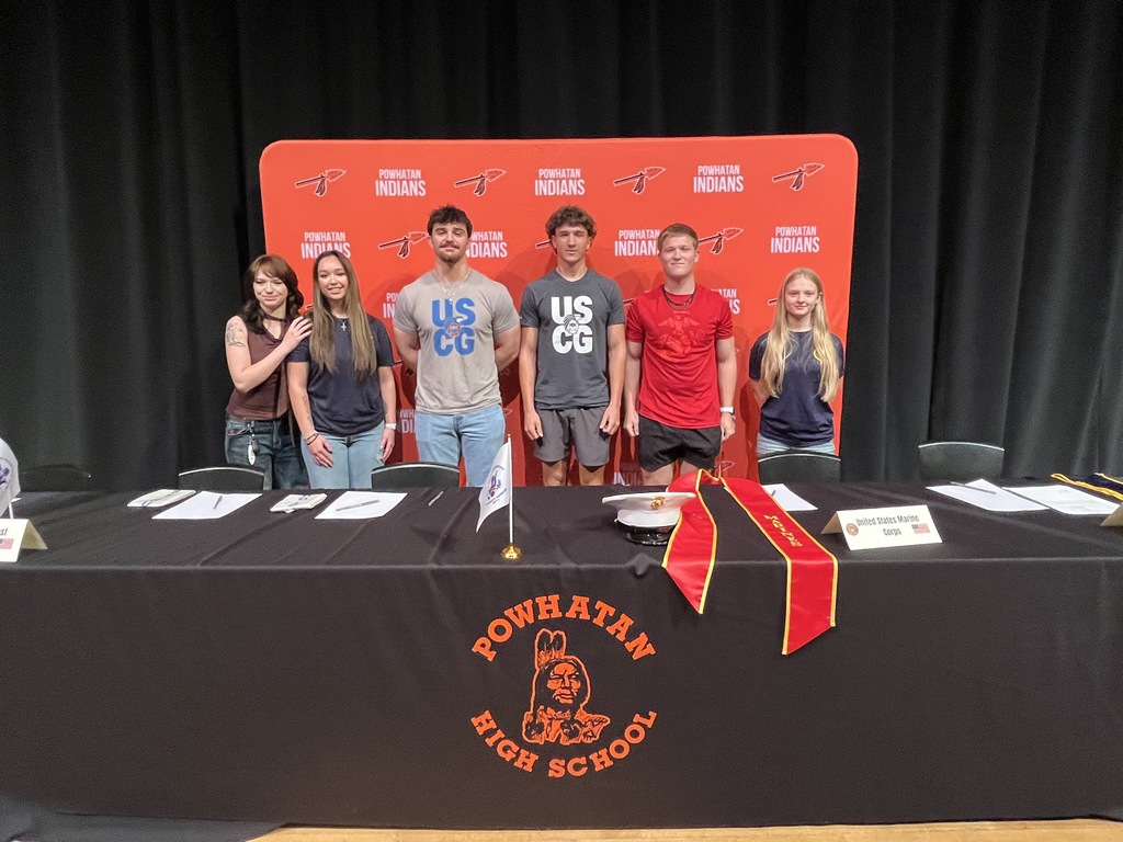 Six high school students pose for a photo in front of a Powhatan Indians backdrop. 