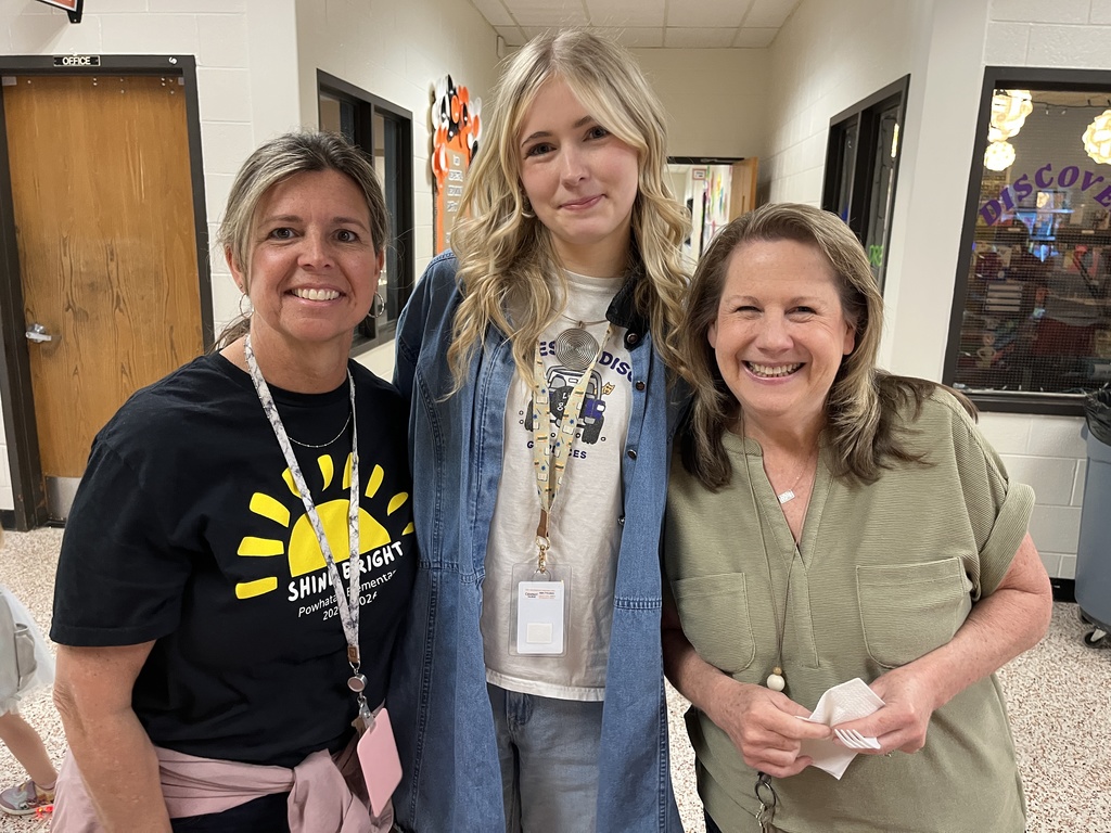 Three staff members pose for a photo at a staff appreciation taco bar at their school