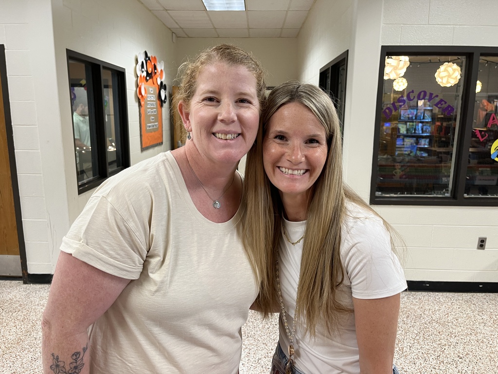 Two staff members pose for a photo at a staff appreciation taco bar at their school