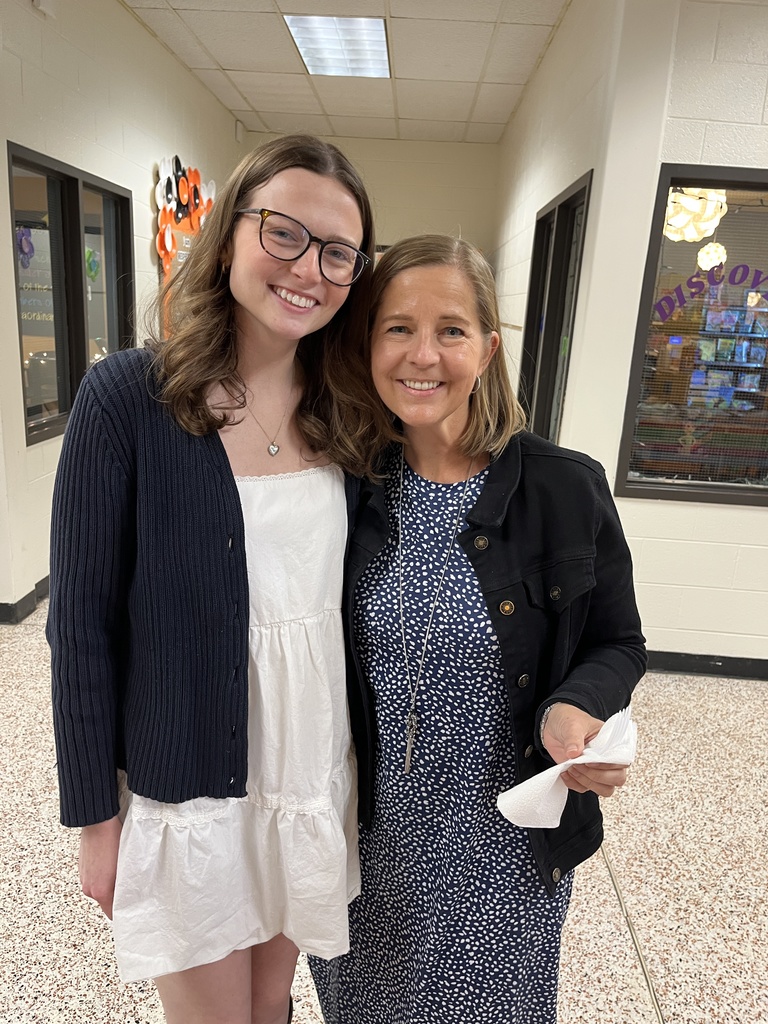 Two staff members pose for a photo at a staff appreciation taco bar at their school
