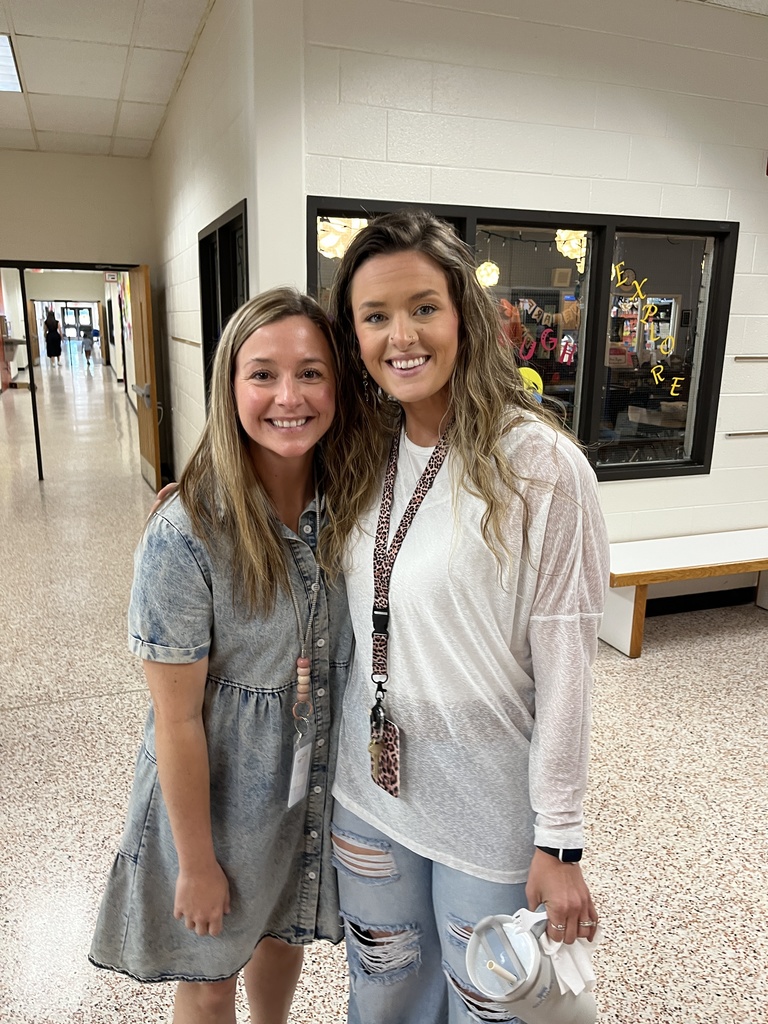 Two staff members pose for a photo at a staff appreciation taco bar at their school