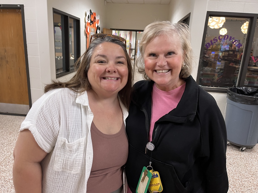 Two staff members pose for a photo at a staff appreciation taco bar at their school