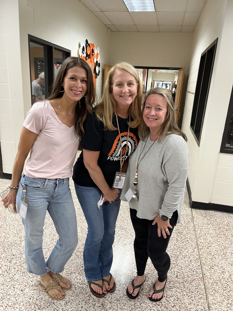 Three staff members pose for a photo at a staff appreciation taco bar at their school