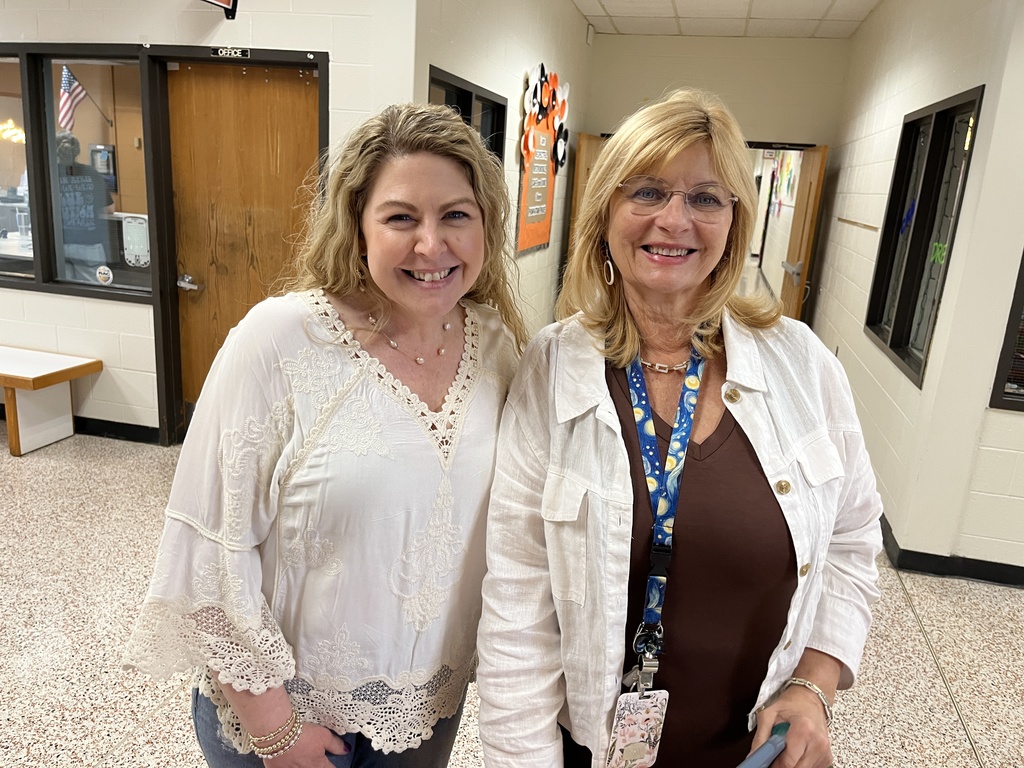 Two staff members pose for a photo at a staff appreciation taco bar at their school