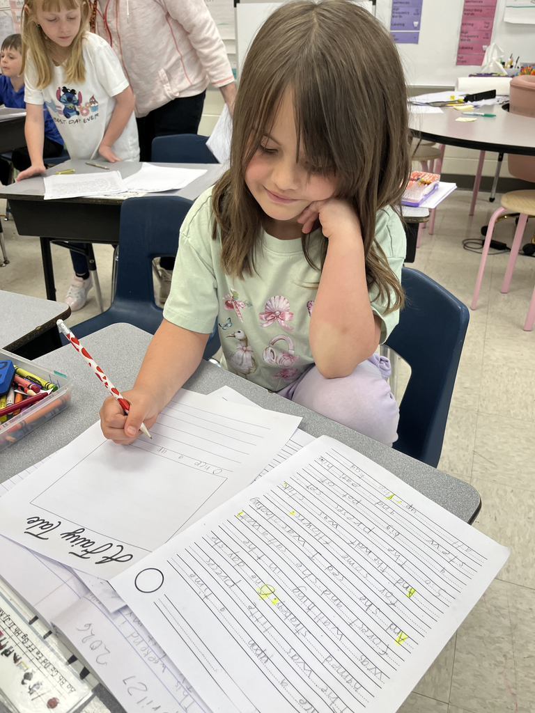 First graders in class work on a fairy tale assignment. 
