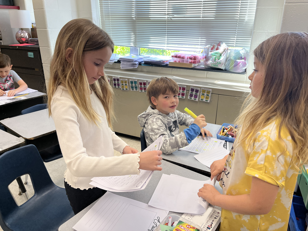 First graders in class work on a fairy tale assignment. 