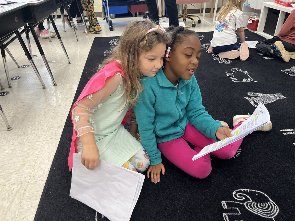 First graders in class work on a fairy tale assignment. 
