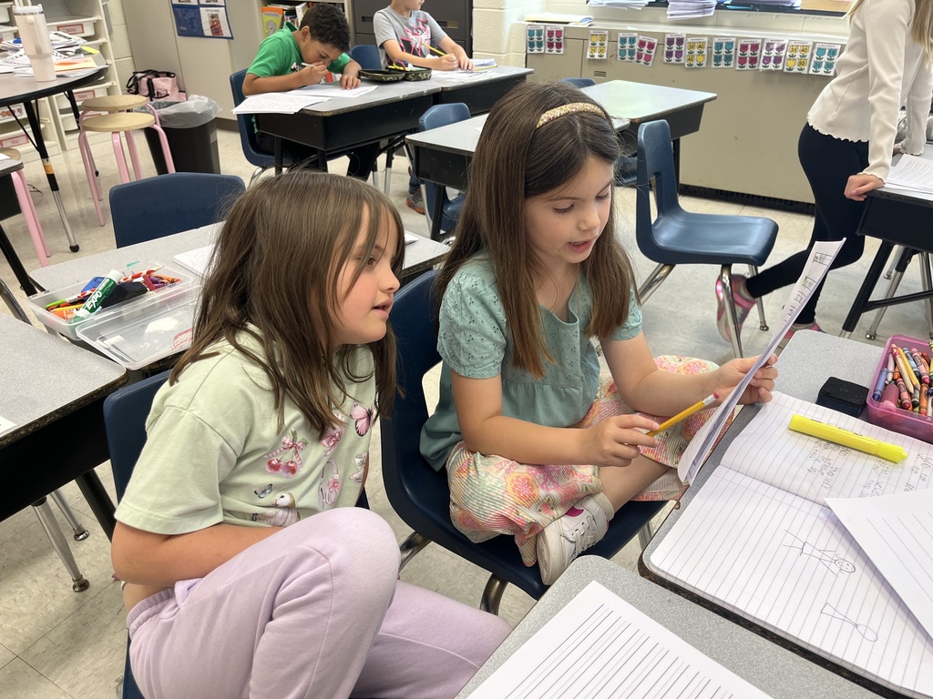 First graders in class work on a fairy tale assignment. 