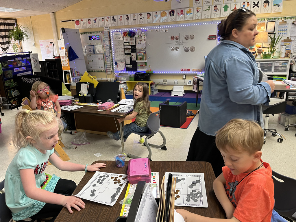 Kindergartners learns about the value of money by working with replica coins. 
