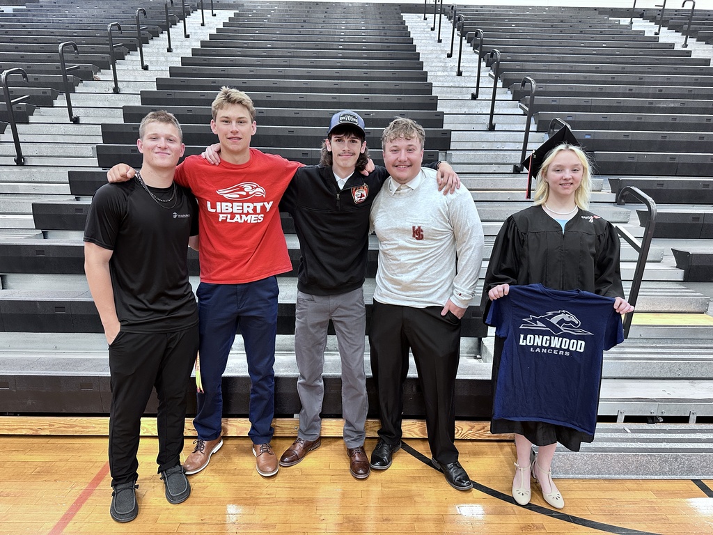 Five graduating seniors pose for a futures-themed photo showing their plans after graduation. 