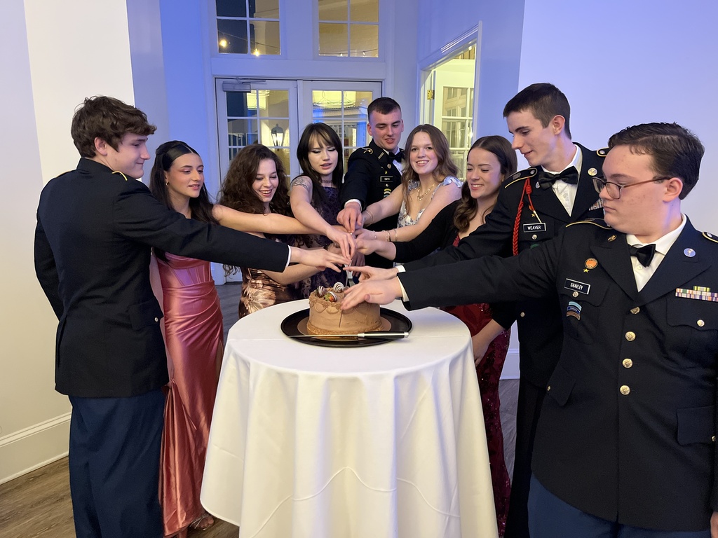 Senior cadets cut a cake during a JROTC military ball.