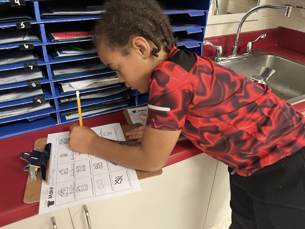 A student works at a literacy station  to practice long vowel sounds .
