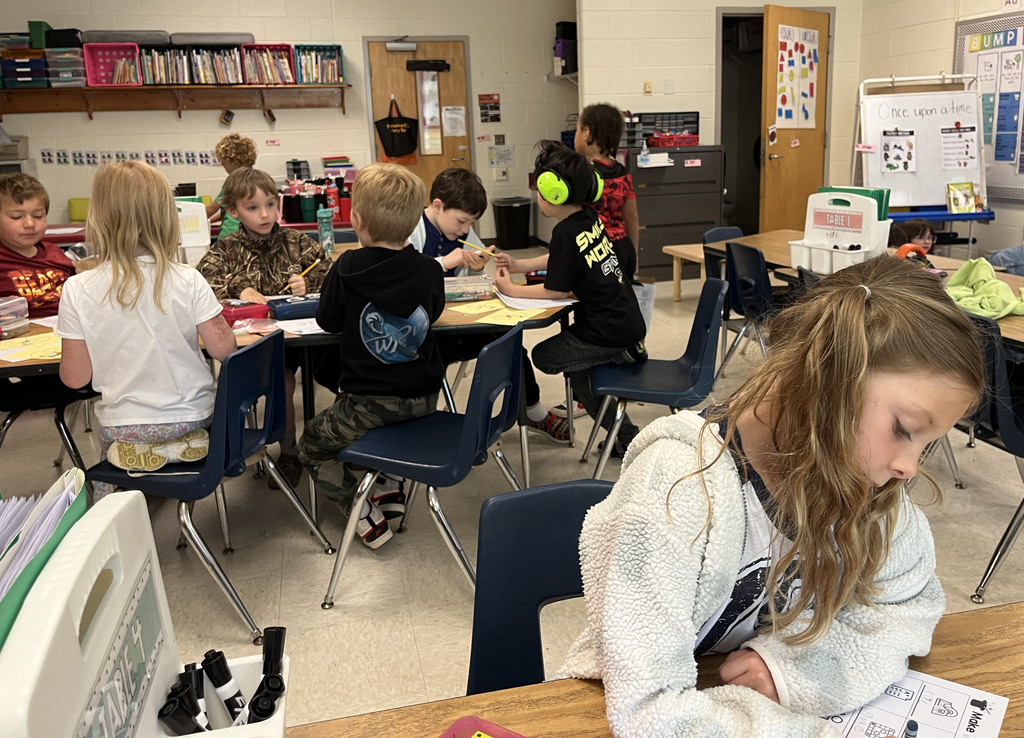 Students work at a literacy station  to practice long vowel sounds .