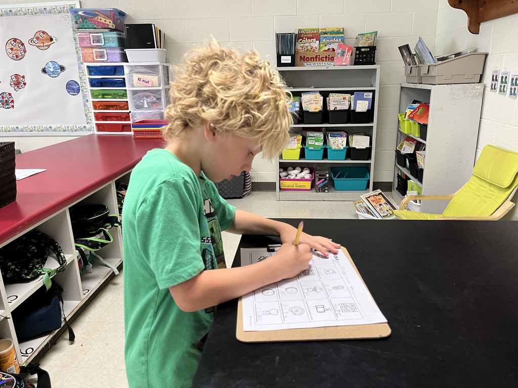 A student works at a literacy station  to practice long vowel sounds .