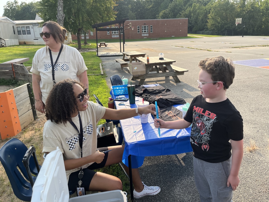 A rising kindergartener gets a popsicle from PTO members.