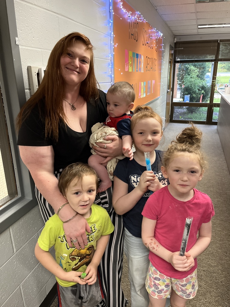 An adult and four children pose for a photo at a preschool information night.