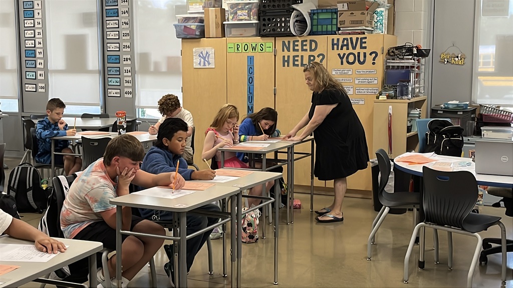 A teacher gives instructions to students on the first day of school.