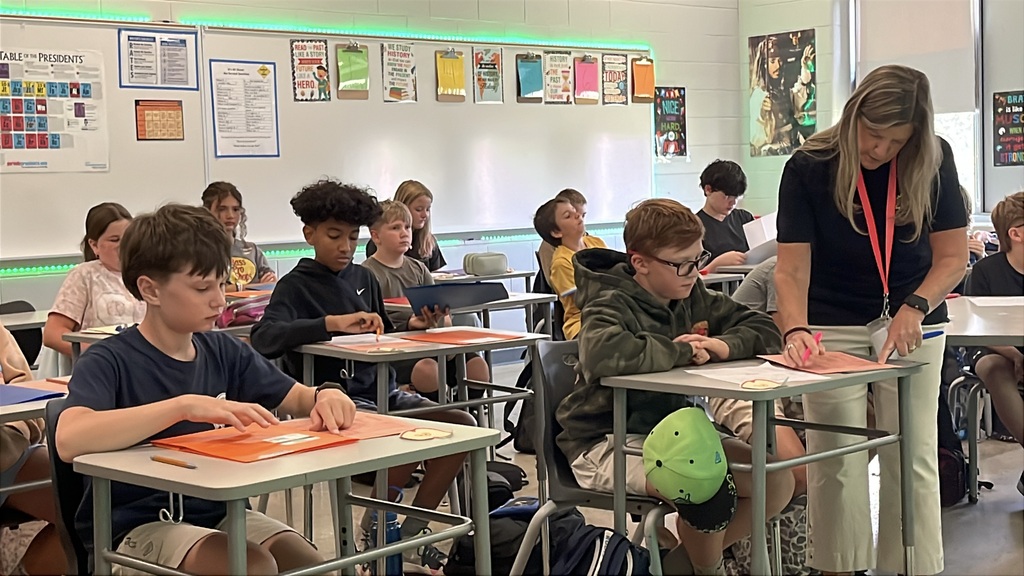 A teacher gives instructions to students on the first day of school.