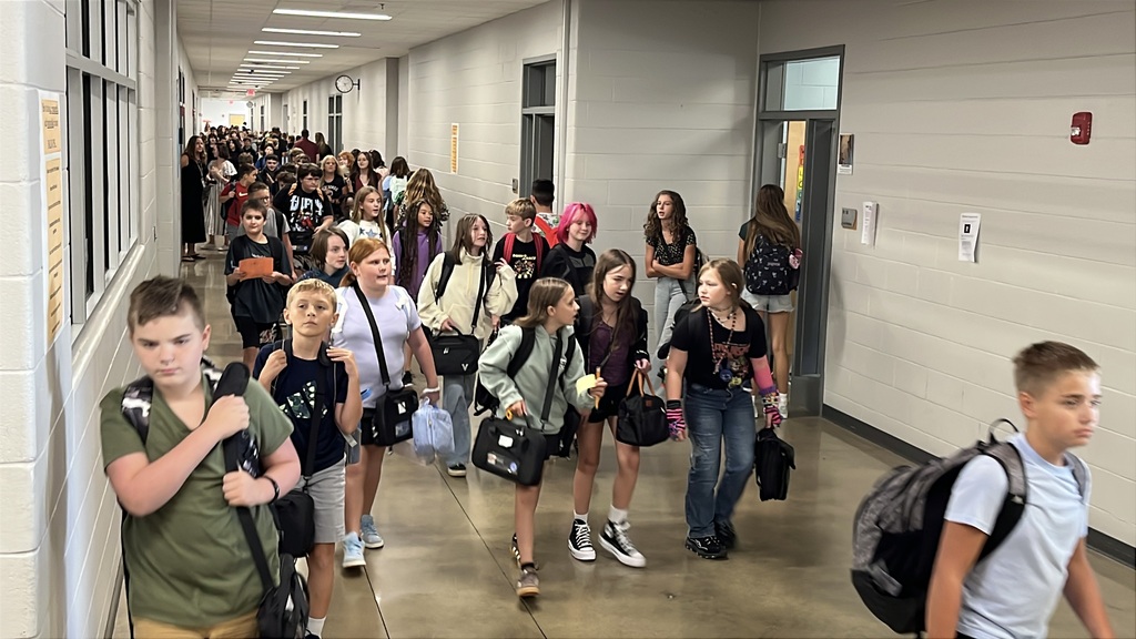 Students walk in the hallway of a middle school.