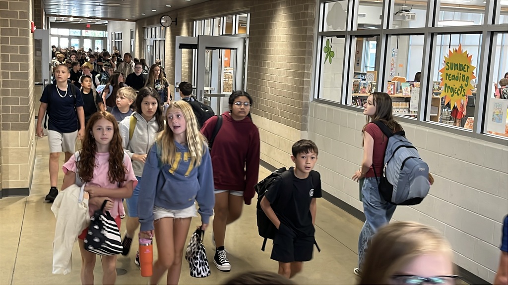 Students walk in the hallway of a middle school.