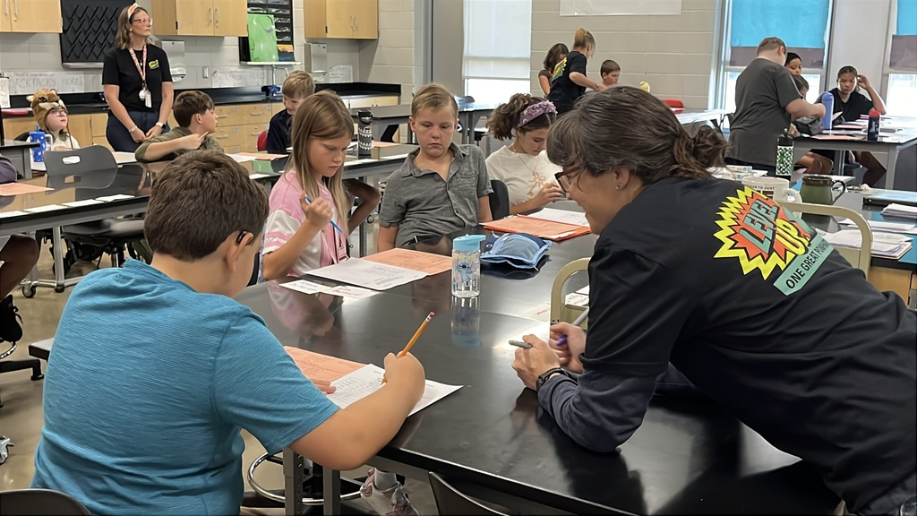 A teacher gives instructions to students on the first day of school.