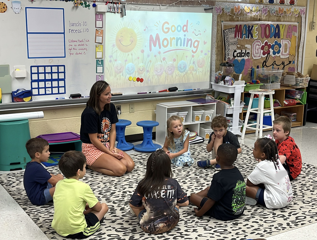 A teacher gives instructions to a classroom on the first day of school. 