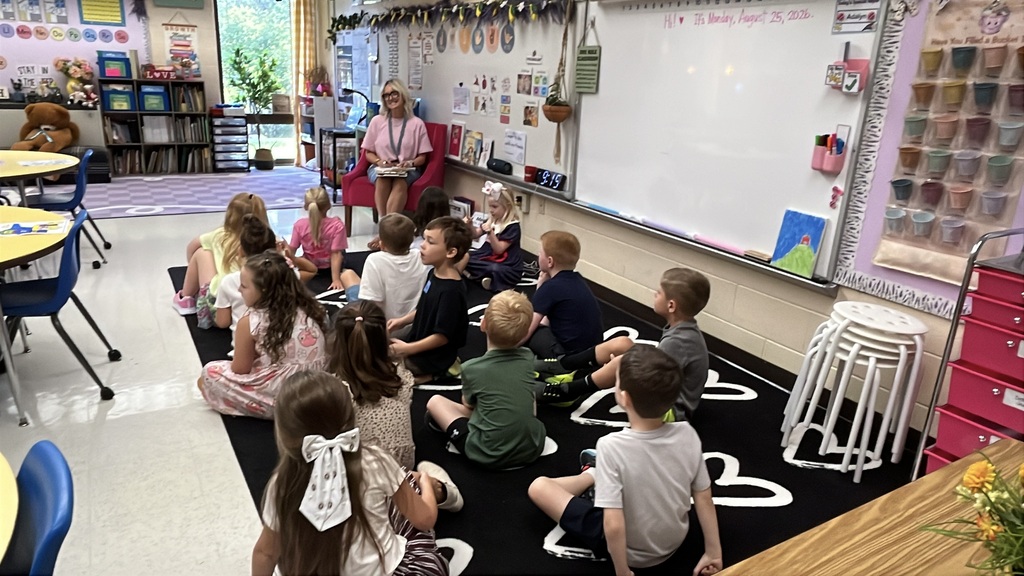 A teacher gives instructions to a classroom on the first day of school. 