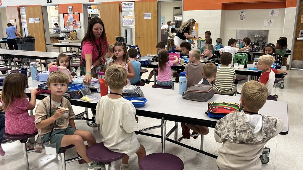 Students eat lunch in the cafeteria on the first day of school.