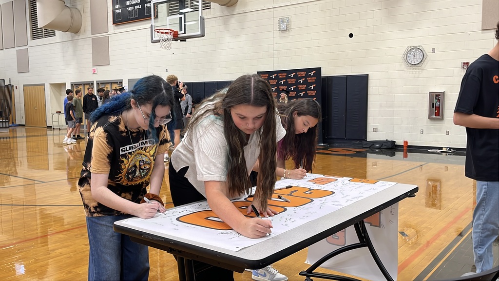 Freshmen sign a Class of 2030 banner on the first day of school.
