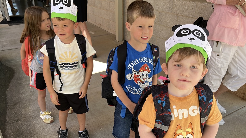 Students walk out of a school on the first day of school.