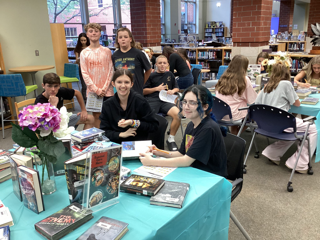 High school freshmen participate in a book tasting event in the school library.
