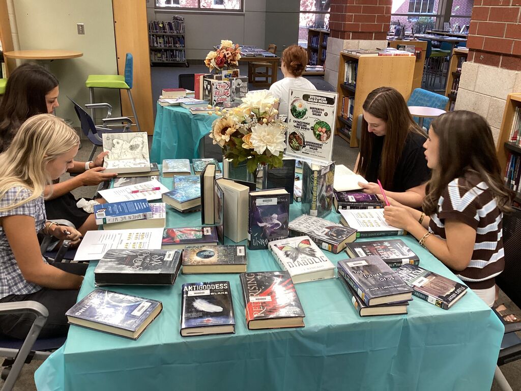 High school freshmen participate in a book tasting event in the school library.