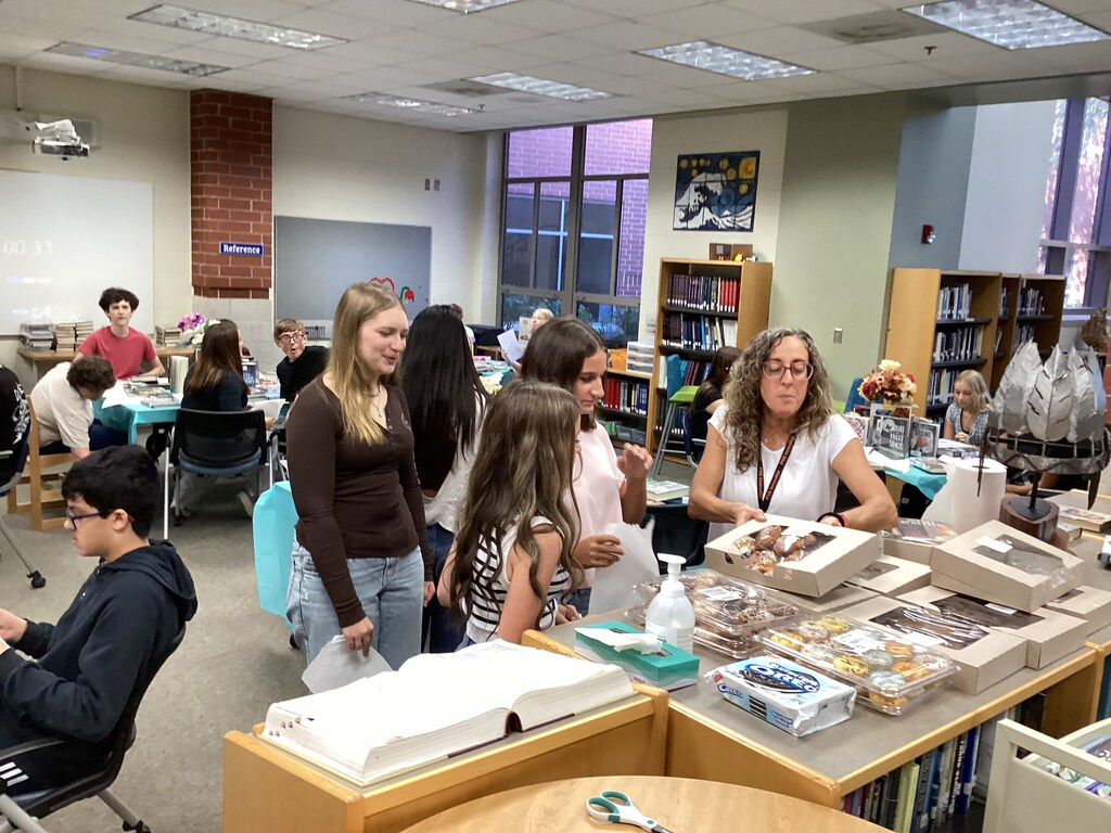 High school freshmen participate in a book tasting event in the school library.