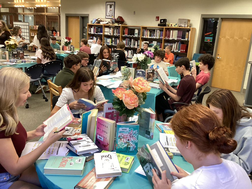 High school freshmen participate in a book tasting event in the school library.