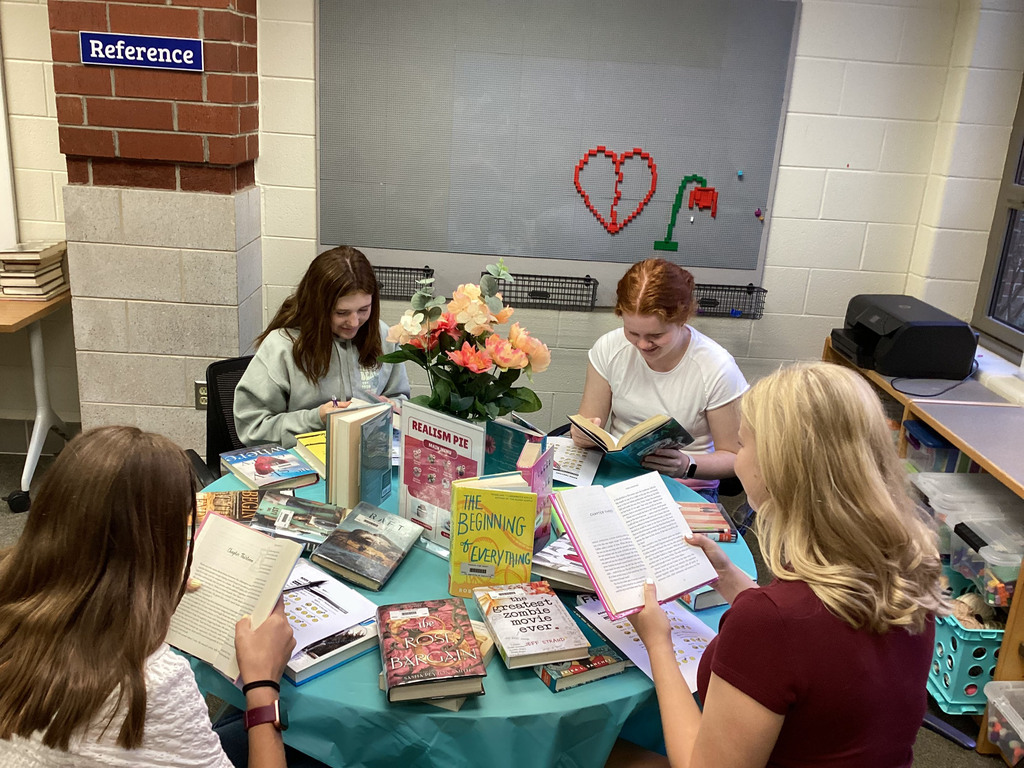 High school freshmen participate in a book tasting event in the school library.