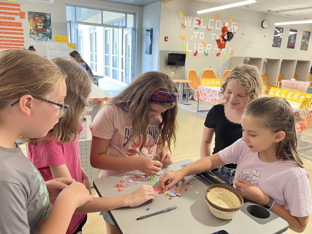 Students look through small plastic prizes to choose one as a prize for participating in an activity. 