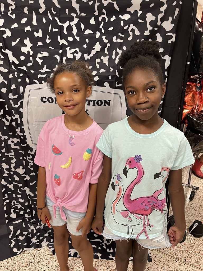 Two children pose for a photo at an elementary open house. 