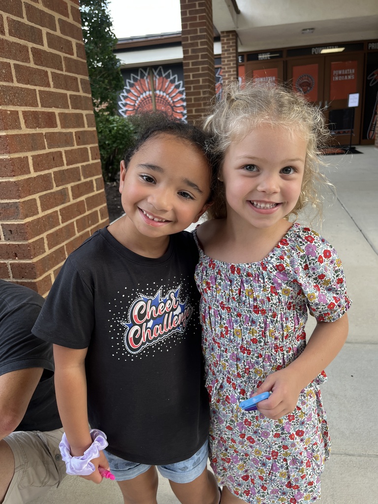 Two children pose for a photo at an elementary open house. 
