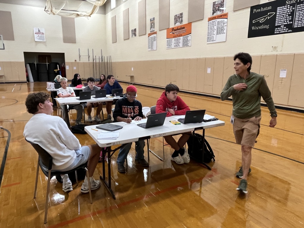 A drivers ed teacher talks to her students about the process of a DMV visit.