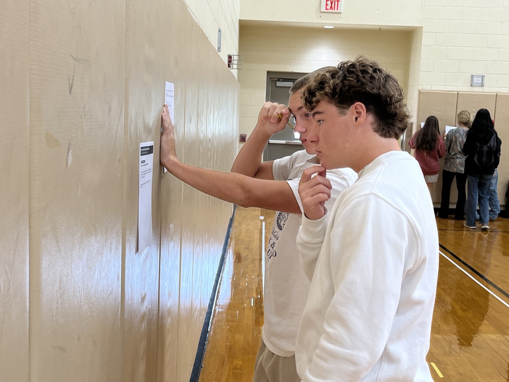 Students in drivers ed class participate in stations to help them learn about the process of a DMV visit.